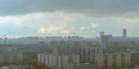 Panorama of a big city, it is snowing, cloudy and clear sky with snowflakes, aerial view of...