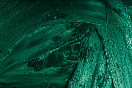 Abstract background with green plaster texture. Seamless background with large brush strokes. Rough stylized texture with space for text. High quality photoの写真素材