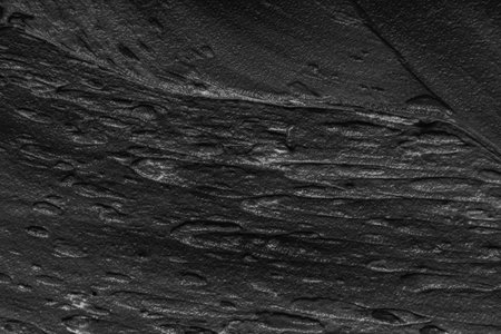 Abstract background with black plaster texture. Seamless background with large brush strokes. Rough stylized texture with space for text. High quality photoの写真素材