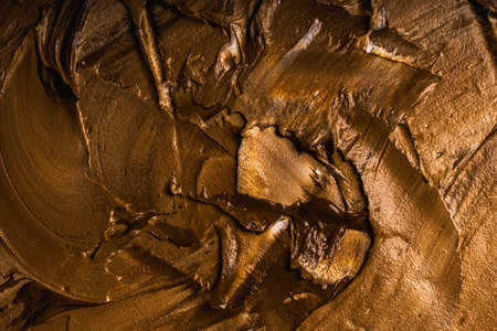 Background with yellow and gold paint texture applied with large strokes of a brush or spatula. High quality photoの写真素材