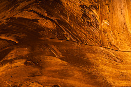 Background with yellow and gold paint texture applied with large strokes of a brush or spatula. High quality photoの写真素材