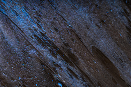 Abstract background with strokes of paint in black and dark blue. Wall or textured wallpaper. High quality photoの写真素材