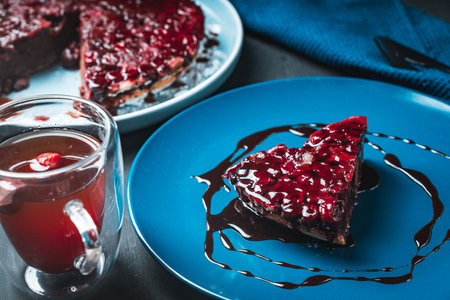 Chocolate dessert, clafoutis with cherries according to a traditional French recipe, on a blue plate...