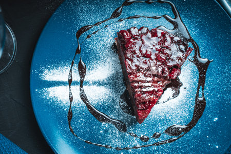 Cherry clafoutis with chocolate on a blue plate. French Cherry Dessert. Top view. High quality photoの写真素材