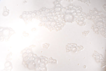Background with milk texture, close-up milk bubbles. High quality photoの写真素材