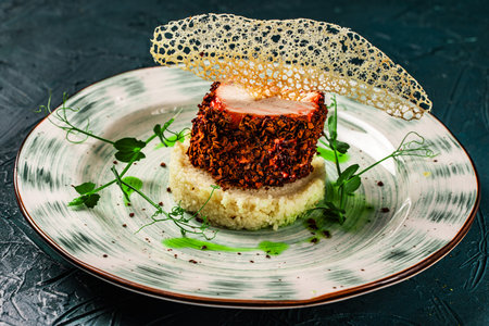 Chicken breast cooked sous vide in beetroot breading with couscous garnish and spinach sauce. Beautiful presentation of the dish. Healthy food concept. High quality photoの写真素材