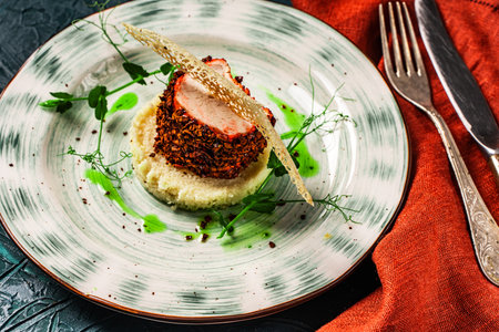 Chicken breast cooked sous vide in beetroot breading with couscous garnish and spinach sauce. Beautiful, restaurant-style presentation of the dish. Healthy food concept. High quality photoの写真素材