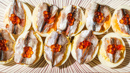 An appetizer of eggs, anchovies on a light plate. View from above. High quality photoの写真素材