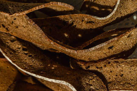 Rye bread is cut into thin slices. Background with the texture of sliced rye bread. High quality photoの写真素材