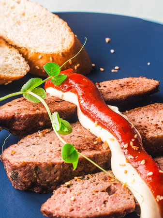 Rye bread toast with microgreens and mayonnaise and ketchup sauce on a blue plate. High quality photoの写真素材