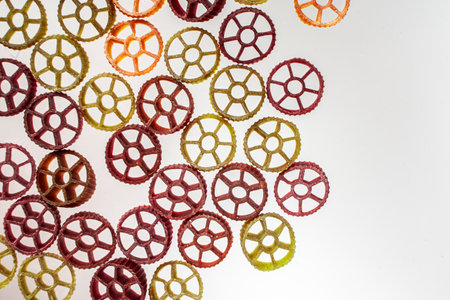 Dry Italian pasta rotelle on white background in the form of a frame. Different flavors and color:...