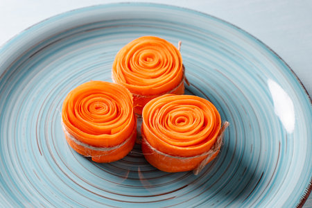 Raw Carrot Rolls Tied With Twine Ready To Fry For Carrot Dessert. Concept: healthy, vegetarian dessert. High quality photoの写真素材
