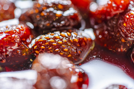 Strawberry jam with whole strawberries close-up. Background of food with candied strawberries. Macro photography. High quality photoの写真素材