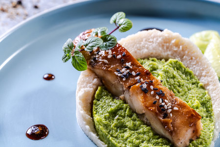 Cod fillet with spinach and broccoli puree and cauliflower on a blue plate. The concept of healthy and dietary nutrition. Restaurant serving of the dish. High quality photoの写真素材