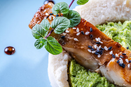Cod fillet with spinach and broccoli puree and cauliflower on a blue plate. The concept of healthy and dietary nutrition. Restaurant serving of the dish. High quality photoの写真素材