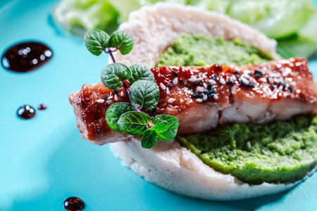 Cod fillet with spinach and broccoli puree and cauliflower on a blue plate. The concept of healthy and dietary nutrition. High quality photoの写真素材