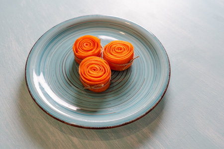Raw Carrot Rolls Tied With Twine Ready To Fry For Carrot Dessert. Concept: healthy, vegetarian...