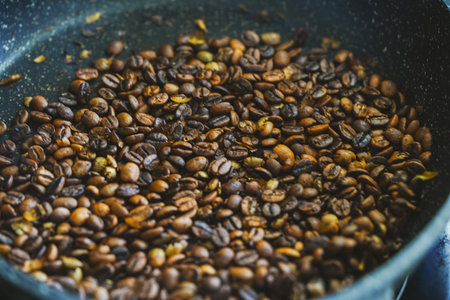 The process of roasting coffee. Coffee beans are roasted in a pan. Close-up. Background. High...