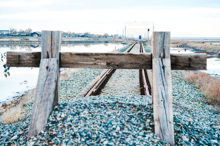 The railway tracks are covered with gravel and covered with a wooden fence. Closed area.の写真素材