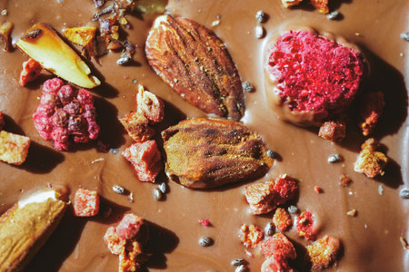 Handmade chocolate close-up. Assorted chocolate with almonds, freeze-dried raspberries and strawberries. . Background for using banners and menus. High quality photoの写真素材