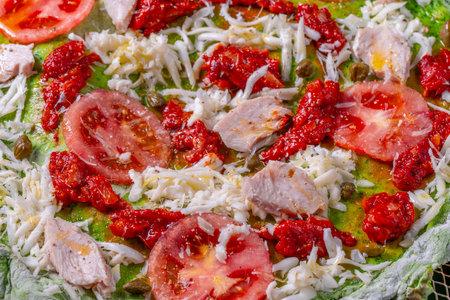 Pizza on green spinach dough with tomatoes and basil. The concept of healthy eating. Close-up. Pizza textured background. High quality photoの写真素材