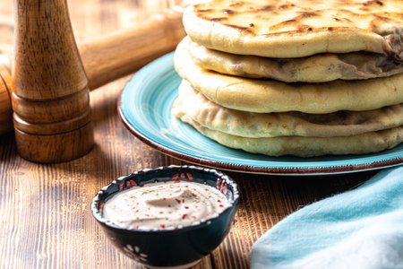 Khychins, traditional Caucasian, Eastern dish. Flatbread stuffed with minced meat with sauce on a...