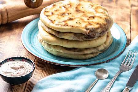 Traditional spanish breakfast potato tortilla. Potatoes in a cast iron frying pan on a rustic wooden...