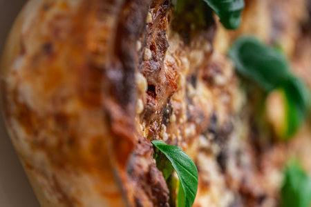 A background with a lasagna texture decorated with basil. Use for templates and banners. View from above. High quality photoの写真素材