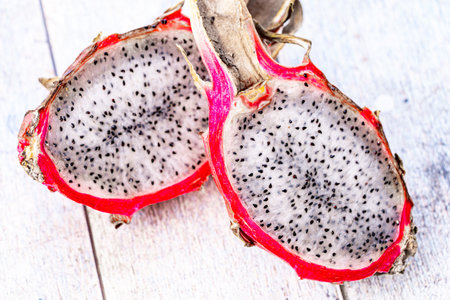 Dragon fruit or Pitahaya is a fruit cut in half on a wooden gray background. Close-up. High quality photoの写真素材