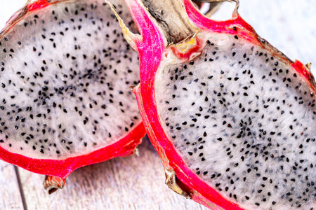 Dragon fruit or Pitahaya is a fruit cut in half on a wooden gray background. Close-up. High quality photoの写真素材