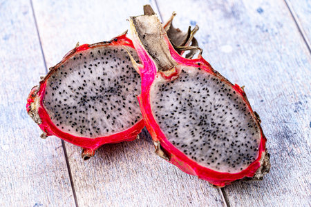 Dragon fruit or Pitahaya is a fruit cut in half on a wooden gray background. Close-up. High quality photoの写真素材