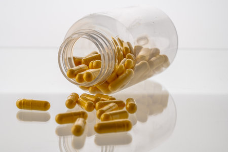 A jar with pills inside lies on a white background. Hyaluronic acid, collagen, vitamins or barberry for losing weight. Medical preparations for health and beauty. Copyspace, banner High quality photoの写真素材