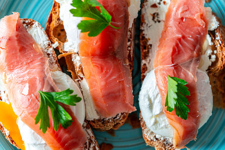 Toast with poached egg, cream cheese and red fish on a blue plate. Delicious and healthy breakfast. Top view. High quality photoの写真素材