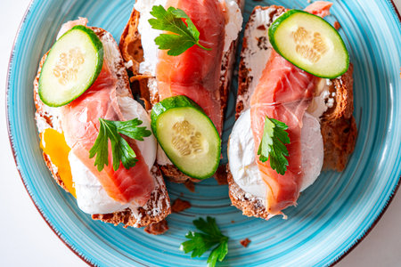 Toast with poached egg, cream cheese and red fish on a blue plate. Delicious and healthy breakfast. Top view. High quality photoの写真素材