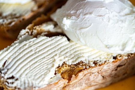 Bread toast is smeared with cottage cheese cream. Close-up. High quality photo