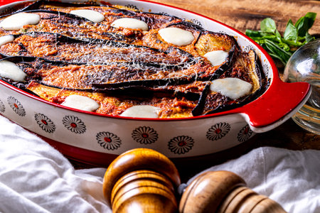 Italian eggplant Melanzane alla parmigiana close up in baking dish on the table. . High quality photoの写真素材