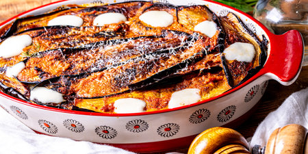 Eggplant baked with tomatoes and cheese in a baking dish on the table with a white napkin. Italian cuisine. High quality photoの写真素材