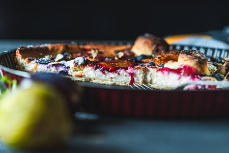 A delicious berry dessert, a piece of tart or an open sweet pie with figs, blueberries and apricots...