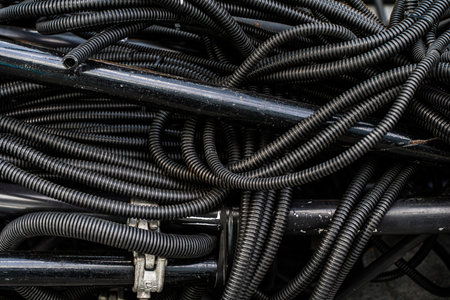 Background, pile of used PVC insulated electrical cords in recycling center for recyclables. High quality photoの写真素材