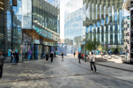 Blurred photo: a business center in a metropolis, modern office buildings with passing people. High quality photoの写真素材