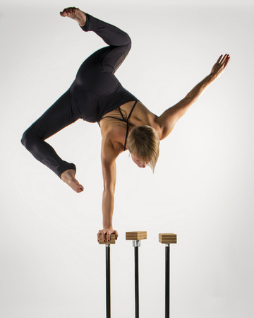 Girl doing a one handed handstand