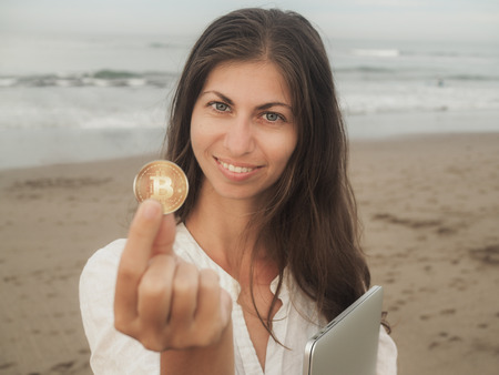 smiling Bitcoin Girl on the beachの写真素材
