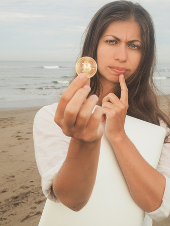 sceptic Bitcoin Girl on the beachの写真素材