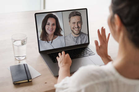 Caucasian woman video conferencing with male colleague on laptop screen. unaltered, business,...