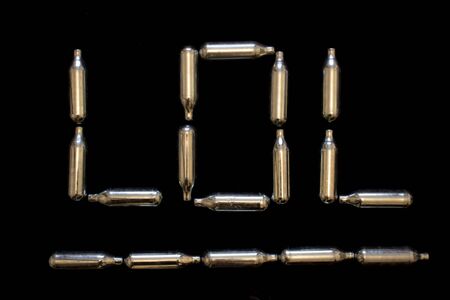 Nitrous Oxide Metal Bulb Canisters Recreational Drugs on Black Background