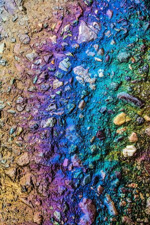 Petrol Oil on a Road Running Down a Gutter Drainの写真素材