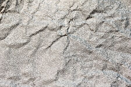 Close Up of Tin Metal Foil Holographic Abstract Backgroundの写真素材