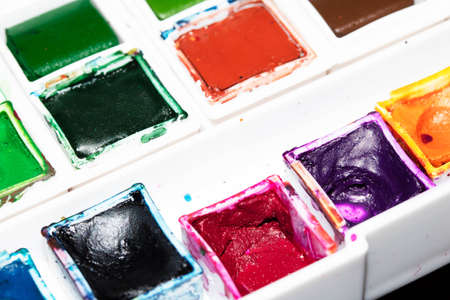 A Colourful Watercolour Pallet of Messy Used Half Pan Paintsの写真素材
