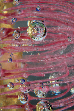 A Vibrant Abstract Glass Swirls and Bubbles from a Paperweight with Lines and Colours