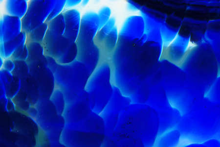 A Vibrant Abstract Glass Swirls and Bubbles from a Paperweight with Lines and Coloursの写真素材